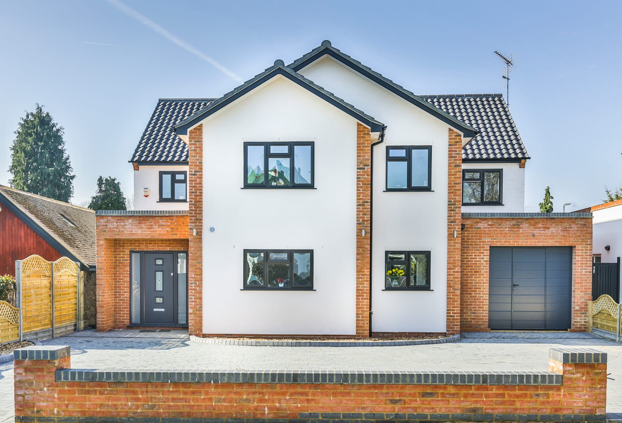 Front elevation, white render and red brick